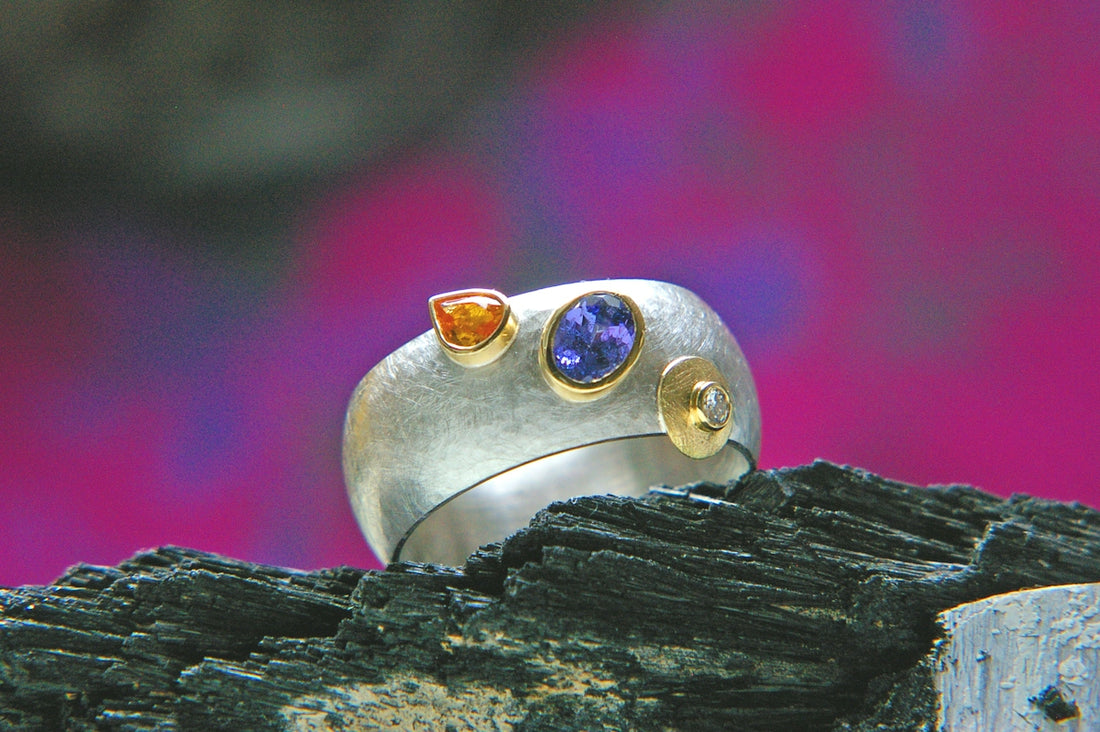 a close up of a ring on a piece of wood